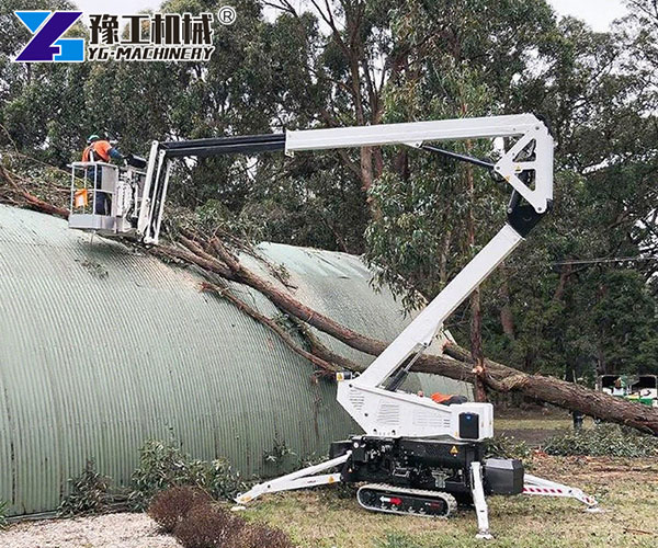Spider lift positioned on uneven outdoor surface