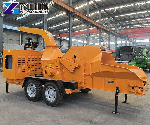 Industrial wood chipper cutting large logs