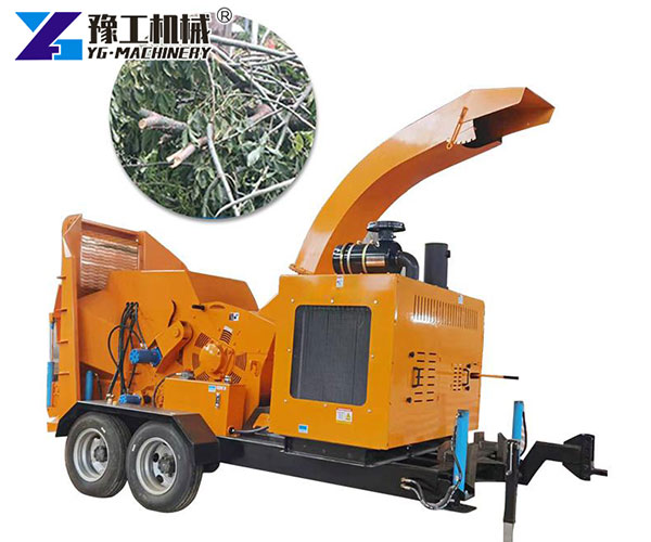 Mobile wood chipper processing tree branches
