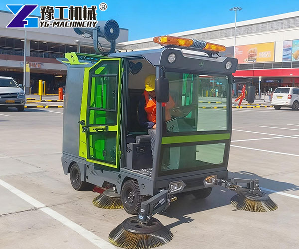 compact street sweeper working in parking lot