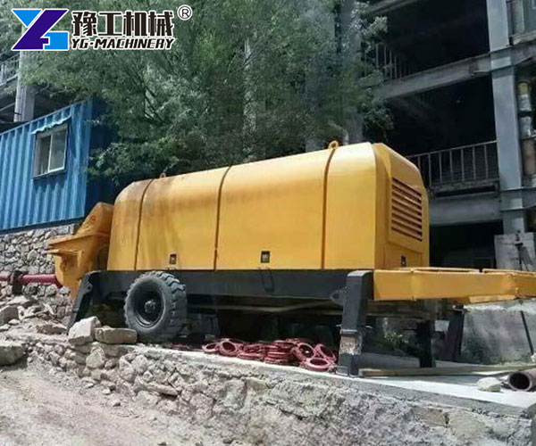 Concrete pump trailer operating on construction site