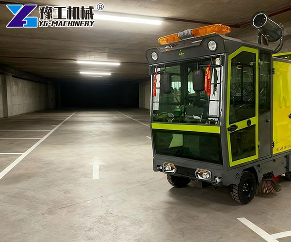 Mini road sweeper machine cleaning the garage