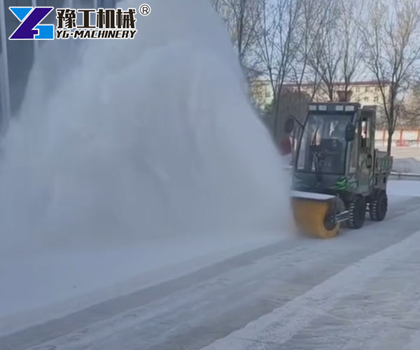 compact sidewalk snow removal machine working
